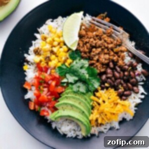 Ultimate Taco Bowl 4 Fully assembled taco bowl with cilantro-lime rice, seasoned beef, and fresh toppings.