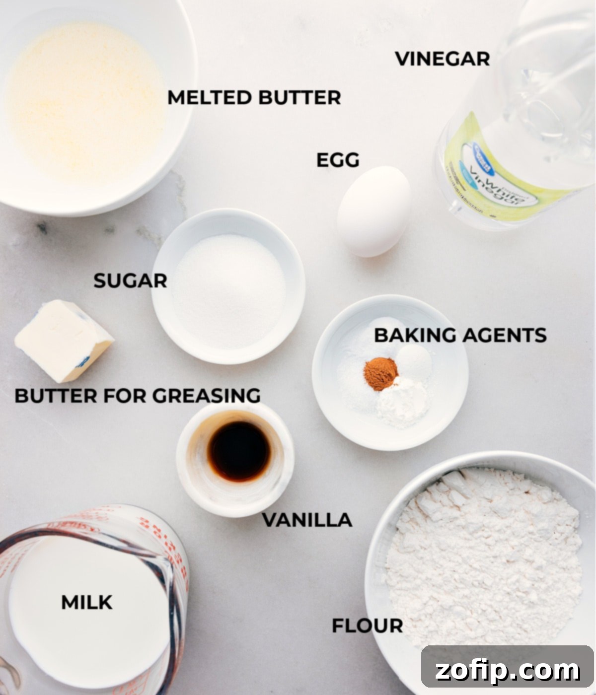 Ingredients for Homemade Old-Fashioned Pancakes An organized display of fresh, high-quality ingredients laid out for making homemade old-fashioned pancakes, including milk, eggs, flour, butter, and leavening agents.