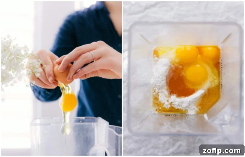Breaking eggs into a blender, where other ingredients are already present, preparing for blending.