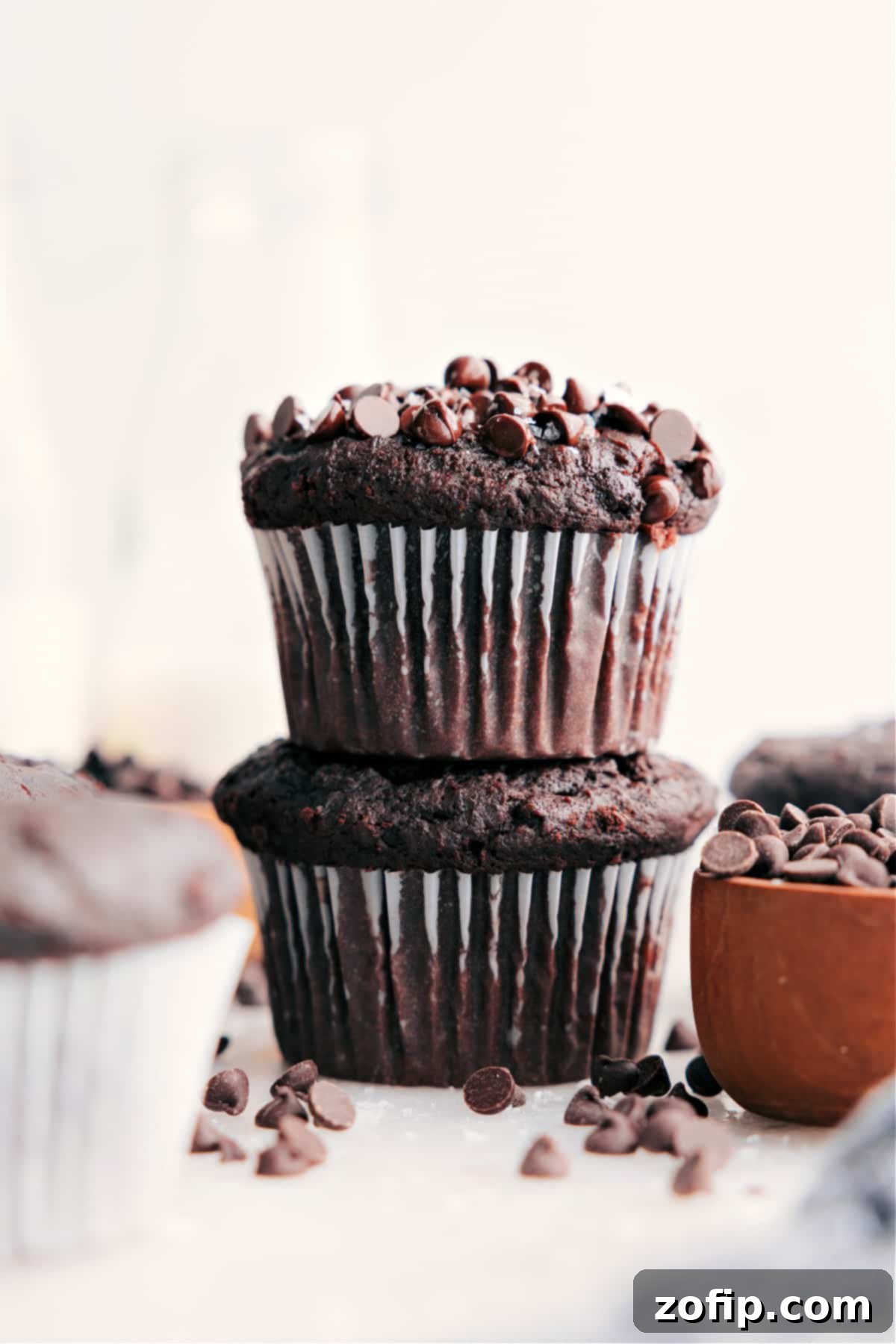 Perfectly stacked, moist double chocolate muffins, ready to be enjoyed as a delightful treat or breakfast.
