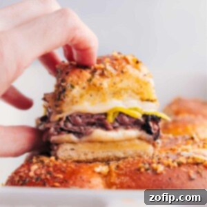 Italian Beef Sliders fresh out of the oven, served on a wooden board.