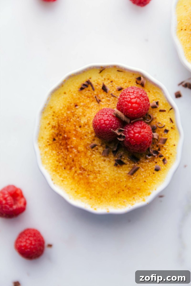 Overhead image of the Tuxedo Crème Brûlée garnished with chocolate curls and raspberries.