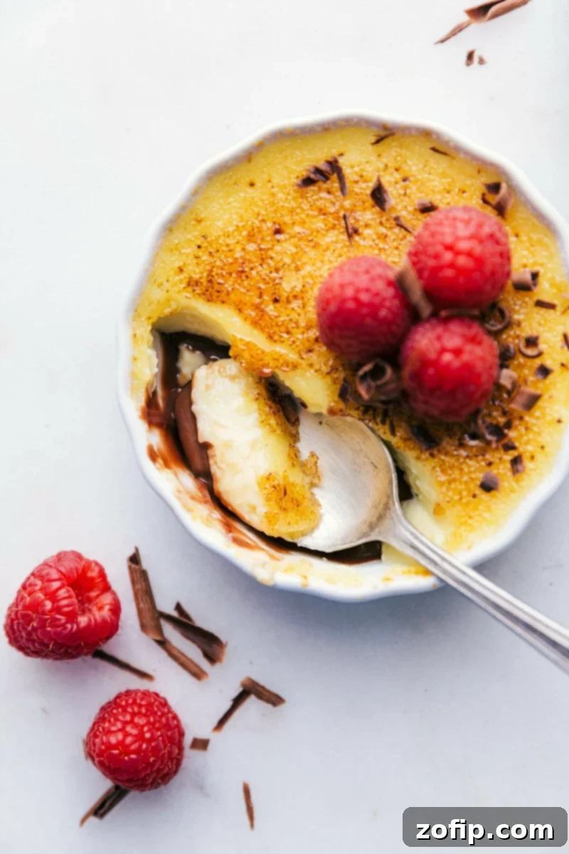 Image of a spoonful being taken out of these Tuxedo crèmes brûlée.
