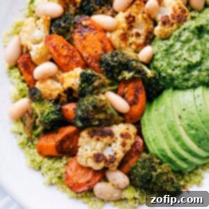 Vibrant Pesto Vegetable Medley 2 Close-up of a Pesto Vegetable Bowl featuring perfectly roasted broccoli, cauliflower, carrots, and white beans over pesto couscous.