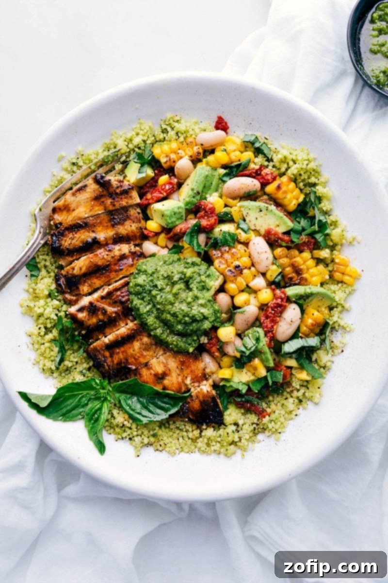 Pesto Chicken Bowls with perfectly cooked chicken, a colorful corn and white bean salsa, and a generous drizzle of vibrant pesto.