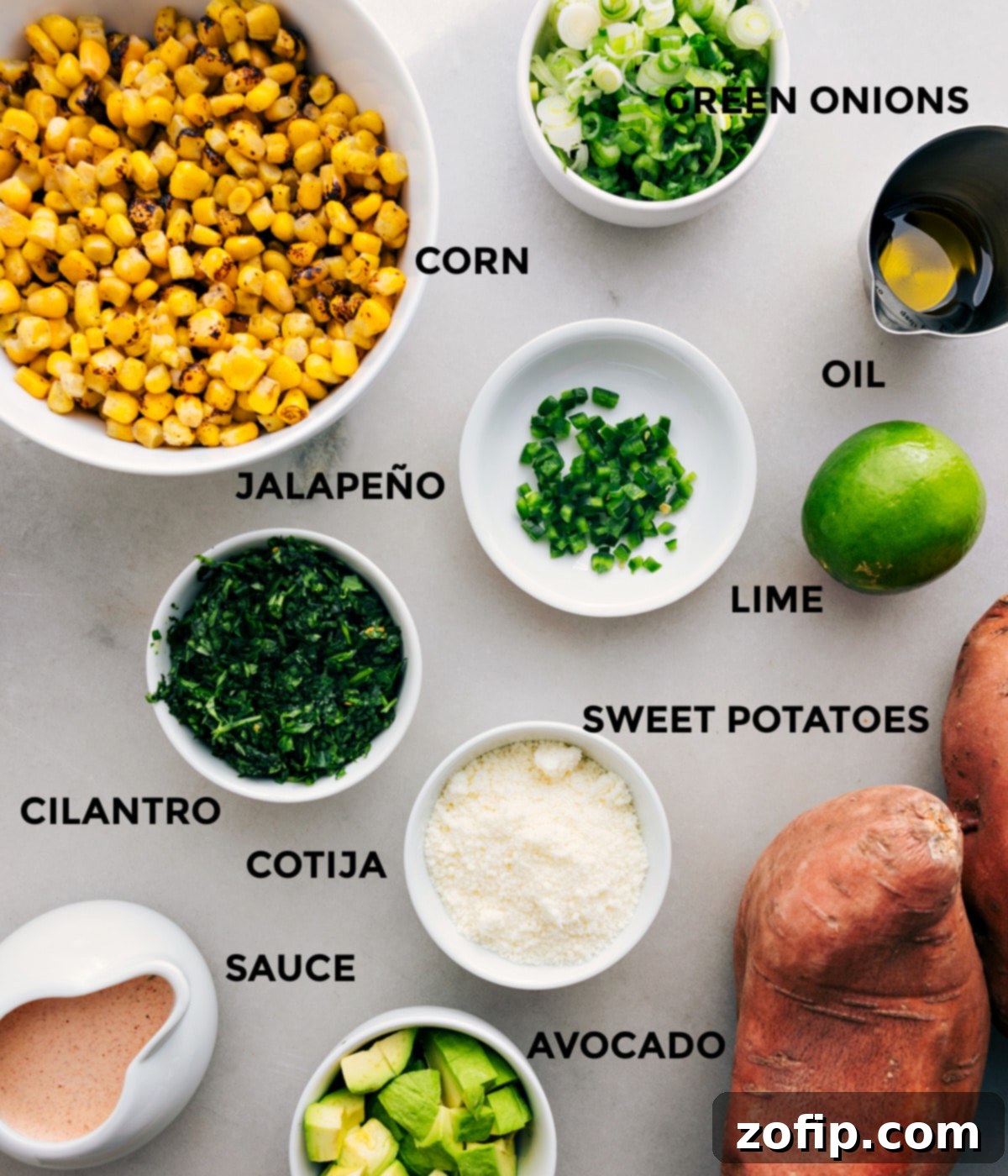 All fresh ingredients prepped for easy assembly: fire-roasted corn, green onions, avocado, lime, jalapeño, Cotija cheese, and sauce components.