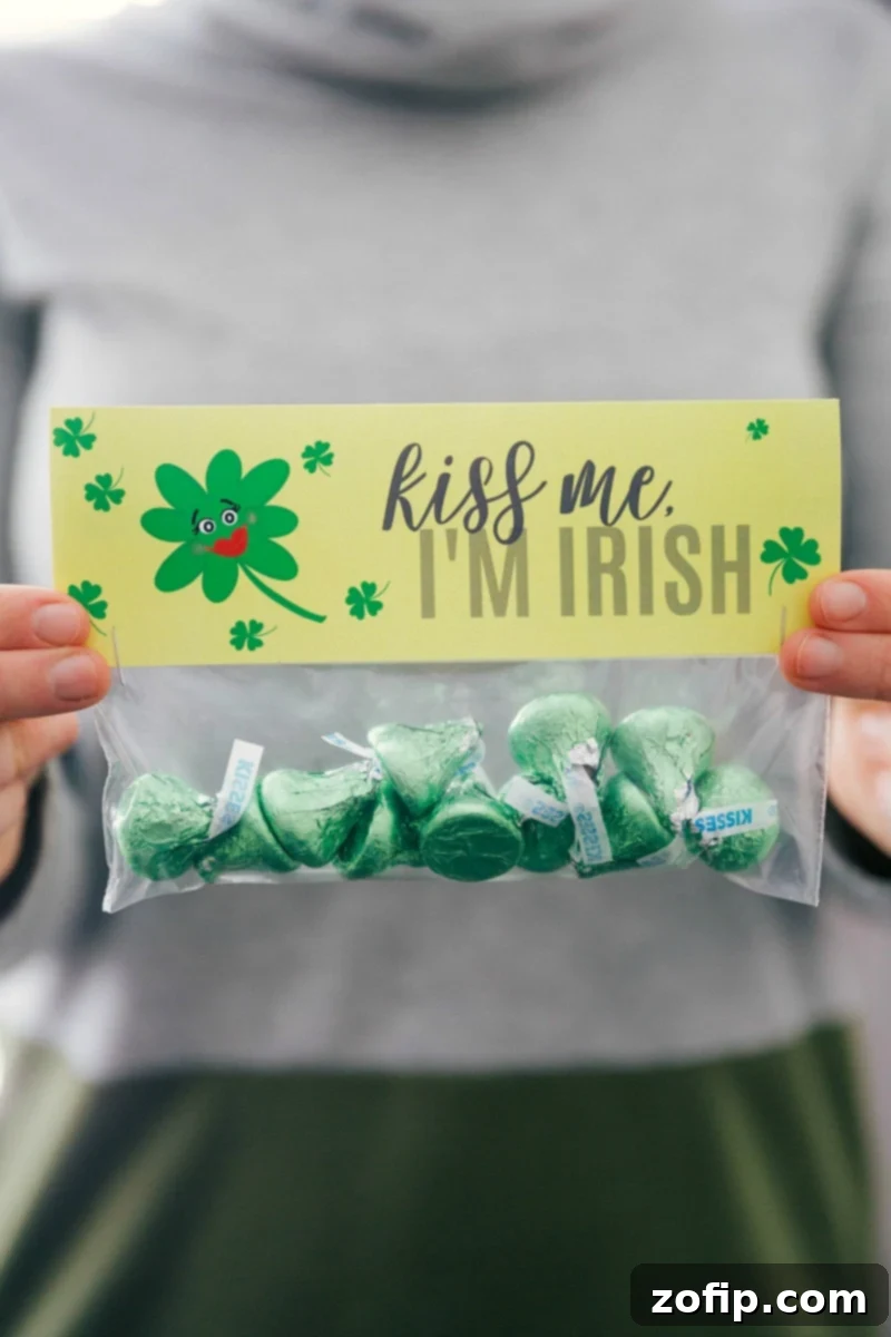 Charming 'Kiss Me, I'm Irish' treat bags, filled with chocolate kisses for St. Patrick's Day. A snack-sized plastic bag filled with chocolate kisses and topped with a 'Kiss Me, I'm Irish' printable bag topper