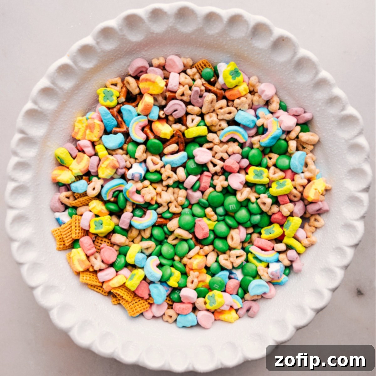 All the dry ingredients for Leprechaun Bait are combined in a large bowl, ready for the melted white chocolate.