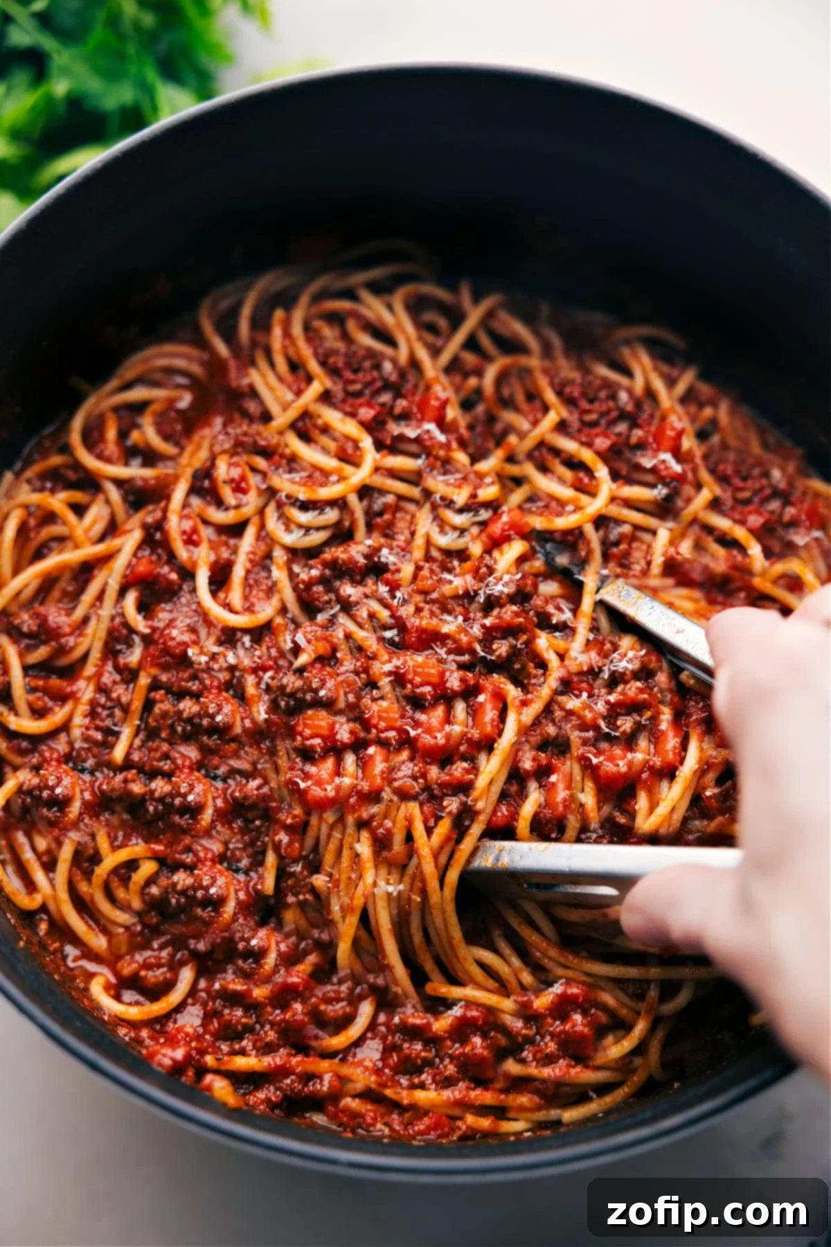 How To Make Spaghetti Bolognese A rich pot of simmering Spaghetti Bolognese sauce, ready to be served with pasta.