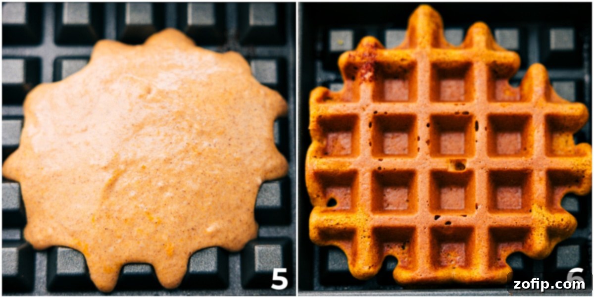 Waffle batter being carefully poured into a hot, preheated waffle maker, with another cooked, golden-brown waffle waiting next to it.