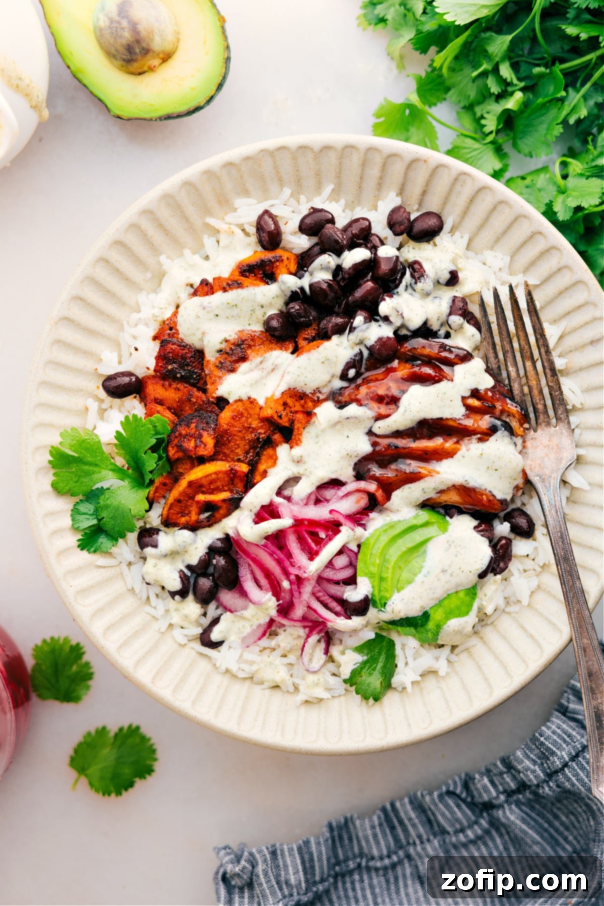 A fully assembled BBQ Chicken Bowl, ready to be enjoyed, with all ingredients visible and dressing drizzled.