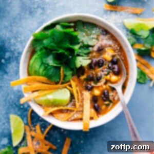A bowl of Crockpot Salsa Verde Chicken Soup, garnished and ready to serve.