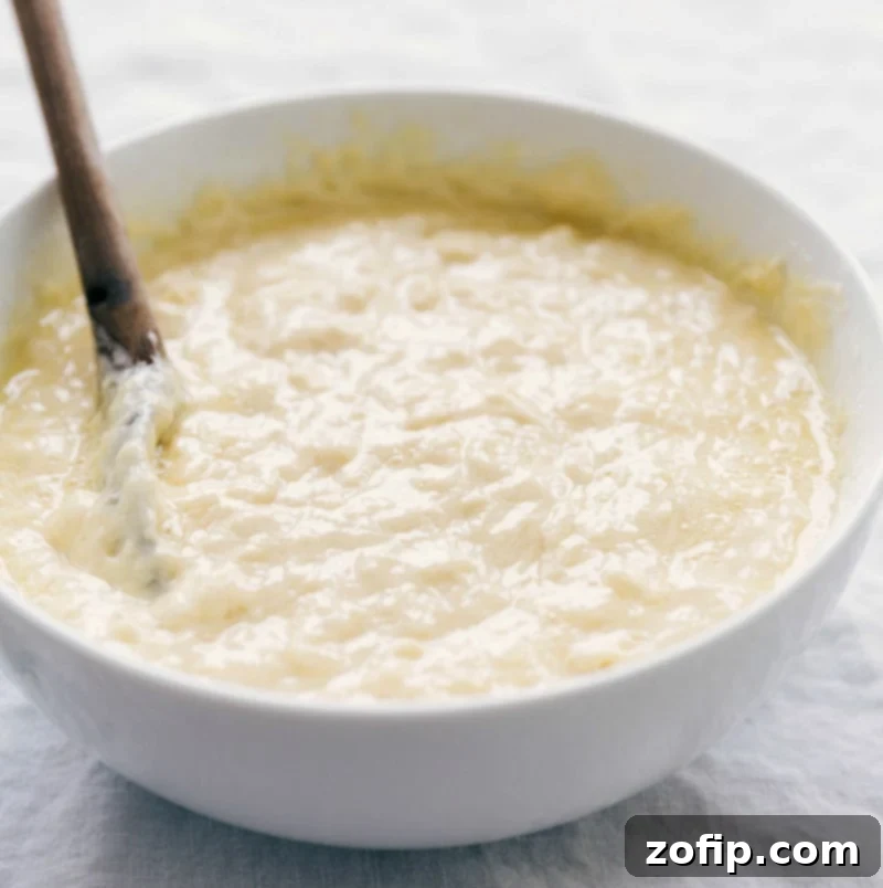 Perfectly mixed waffle batter in a bowl, ready to be poured into the waffle iron.