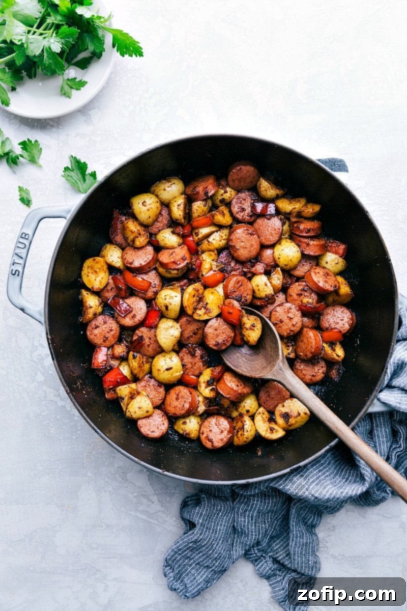 Overhead photo of a vibrant Sausage and Potatoes Skillet meal, featuring crispy potatoes, savory sausage, and colorful peppers, ready to be served.