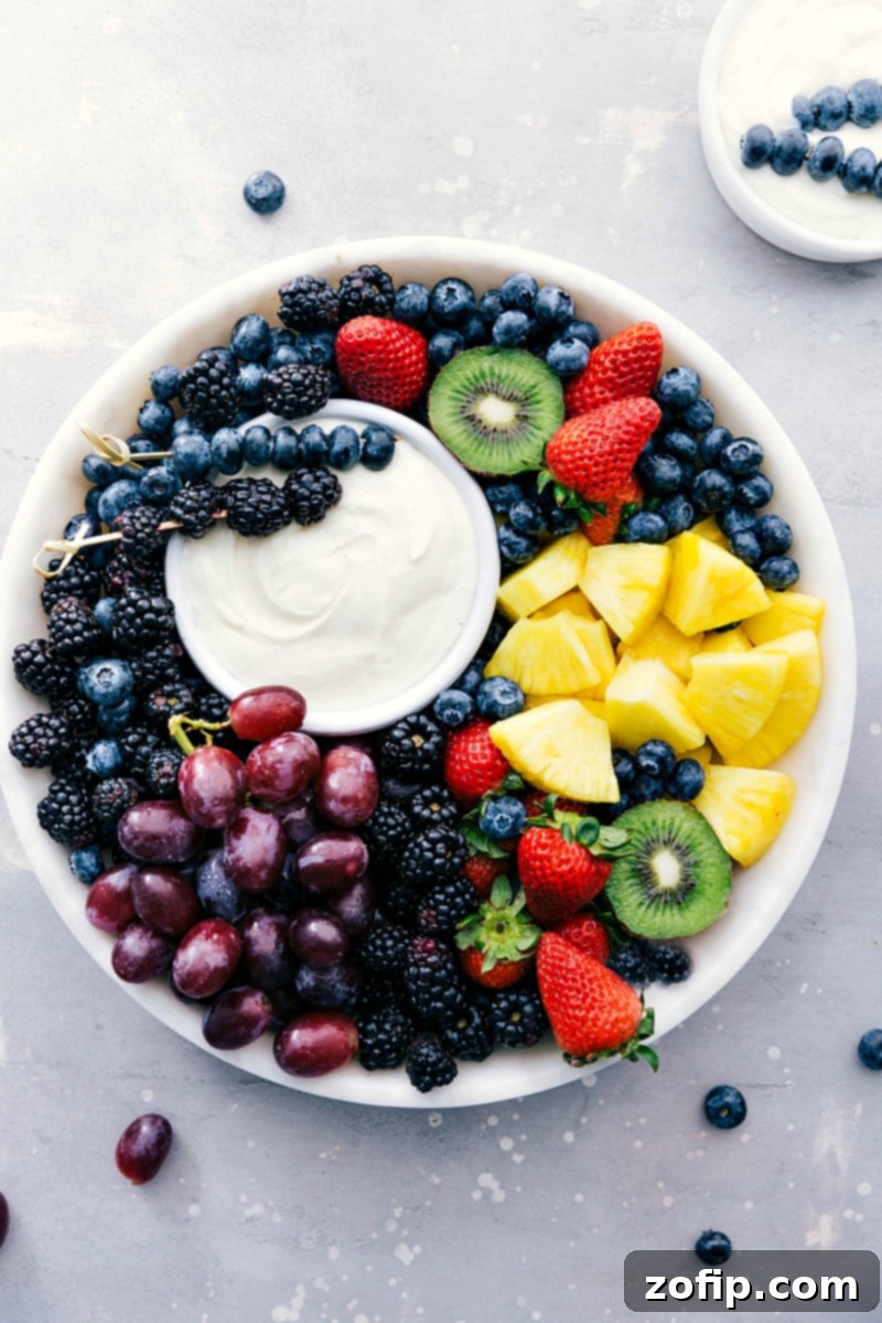 Image of the ready-to-eat Fruit Dip with a variety of colorful fresh fruit, including grapes, berries, and pineapple, beautifully arranged on a platter, ready for dipping.