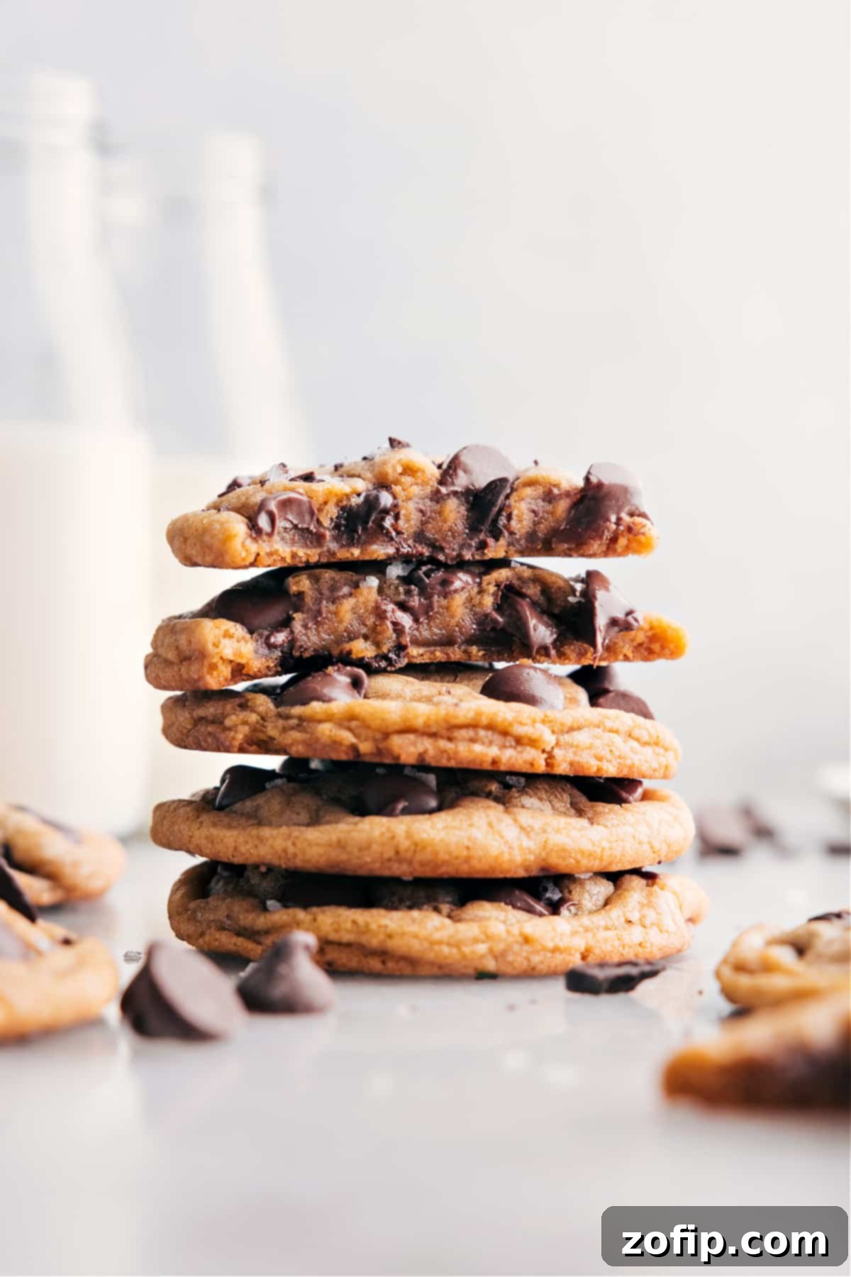 Irresistibly Chewy Chocolate Chip Cookies A stack of perfectly baked chewy chocolate chip cookies with melted chocolate chips visible.