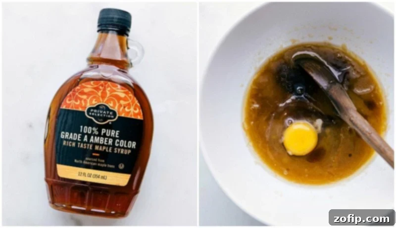 Key Additions: Incorporating Maple Syrup and Egg for Enhanced Cookie Texture A bottle of pure maple syrup and a fresh egg being carefully added to the mixing bowl containing the butter and sugar mixture for the cookie recipe.