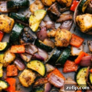 Baked Gnocchi with vegetables, still on the sheet pan, fresh out of the oven, garnished with Parmesan.