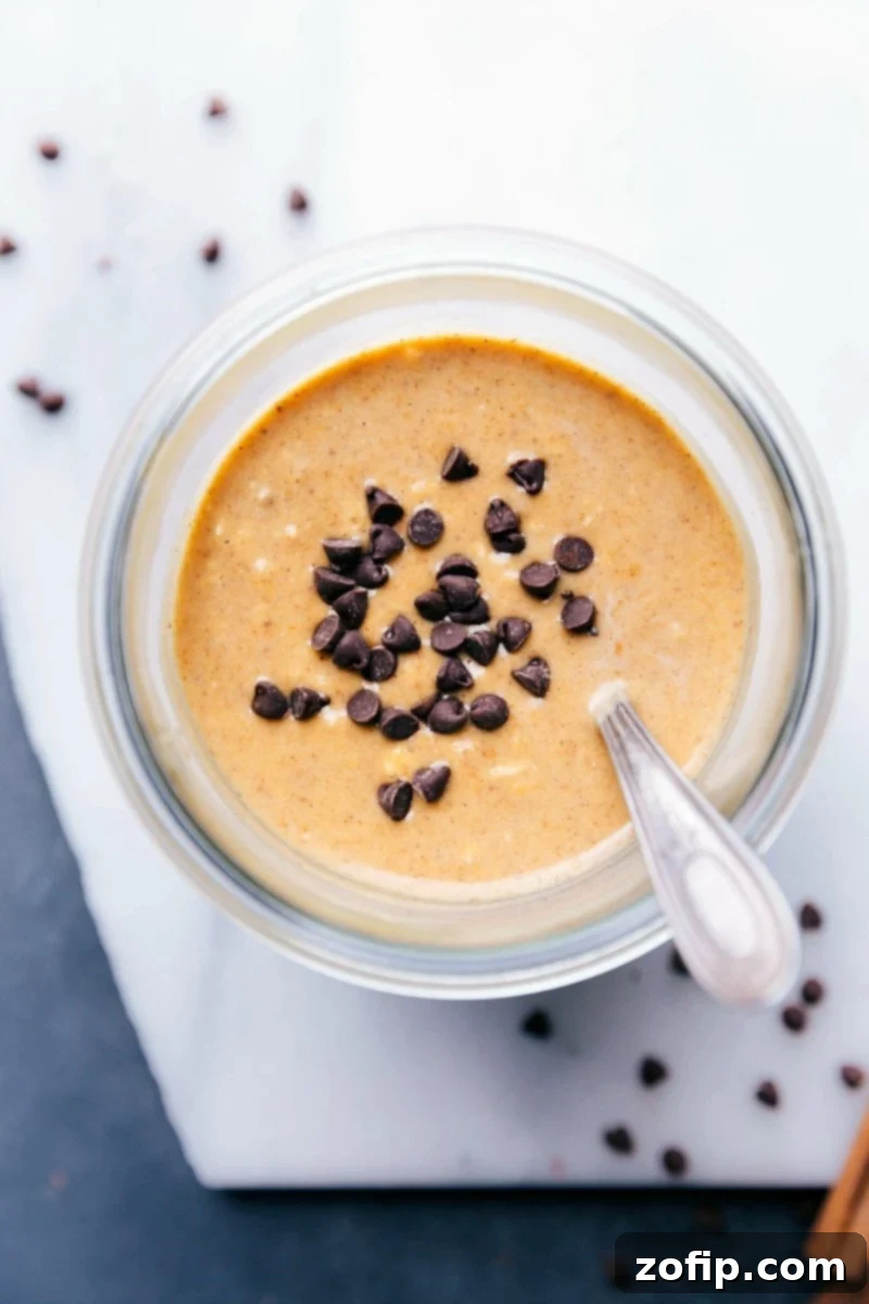 Pumpkin overnight oats topped with chocolate chips, prepared and ready for on-the-go enjoyment. A perfect healthy fall breakfast.