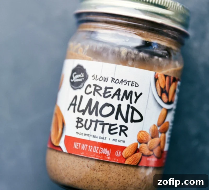 A jar of the preferred creamy almond butter used in this recipe, highlighting a key ingredient for texture and flavor contribution to the pumpkin oats.