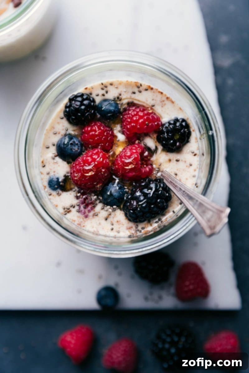 Berry overnight oats, healthy and ready for on-the-go consumption, topped with an assortment of fresh berries like blueberries and raspberries.