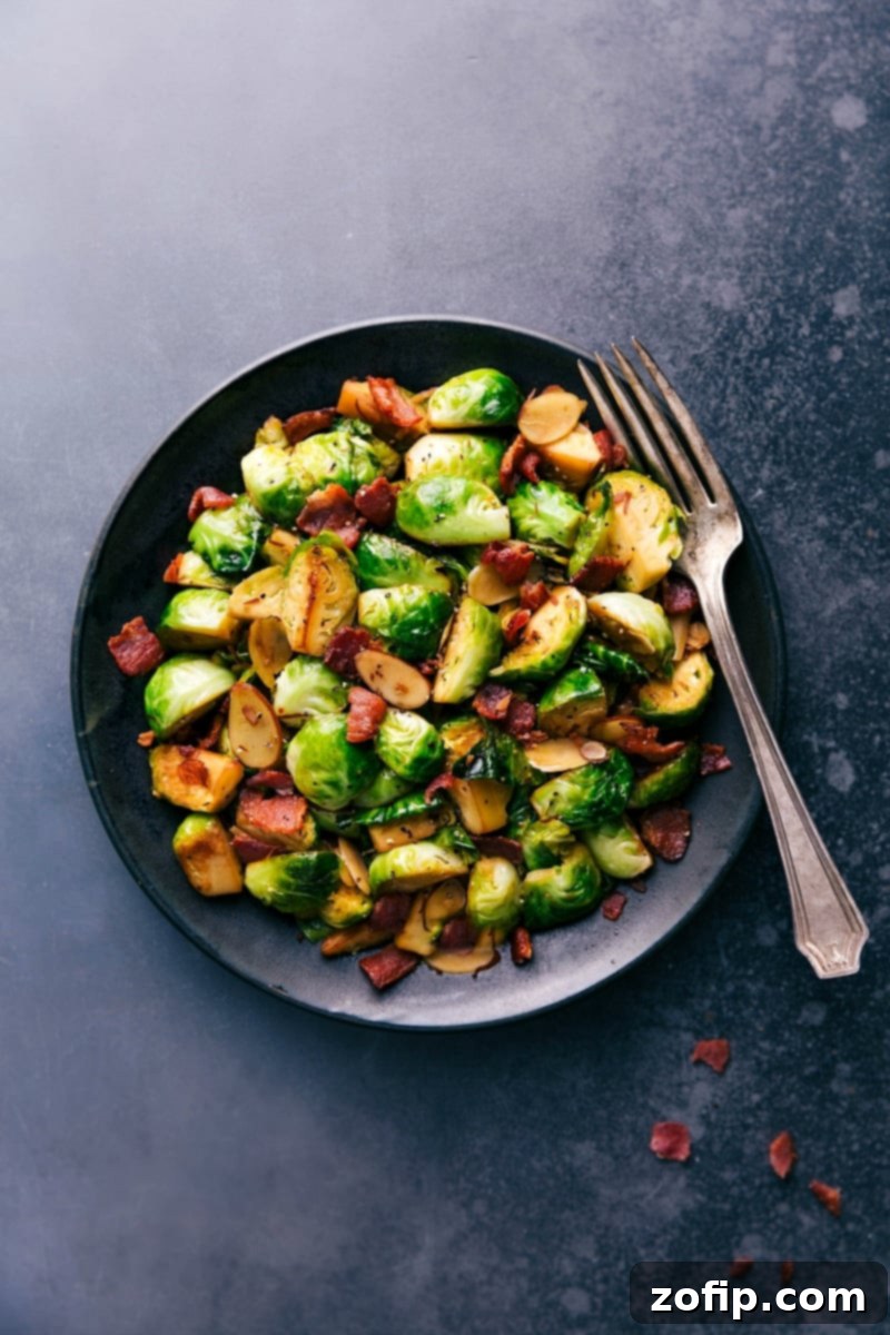 A vibrant plate of perfectly cooked Brussels sprouts and crispy bacon, ready to be served and enjoyed.