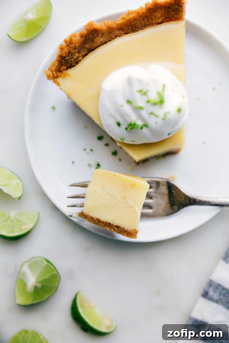 A delicious sweet and tangy slice of dessert with a bite taken out of it, showcasing the creamy filling and crisp crust.