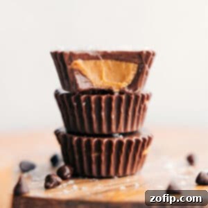 Close-up of a homemade peanut butter cup, showcasing its perfectly layered chocolate and creamy filling.