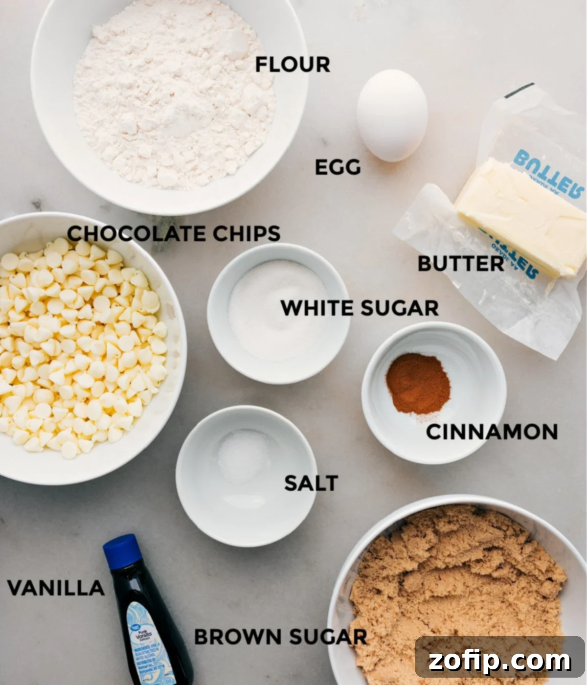 Essential Ingredients for Perfect Snickerdoodle Blondies A curated selection of fresh ingredients including brown sugar, eggs, butter, flour, cinnamon, salt, and white chocolate chips, all prepped for making Snickerdoodle Blondies.