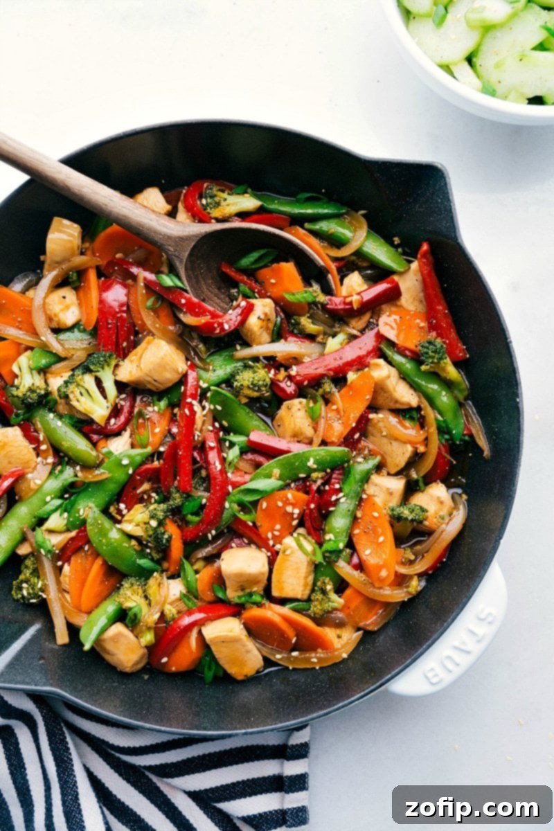Chicken stir fry in a skillet, brimming with vegetables and rich flavors, prepared for serving.