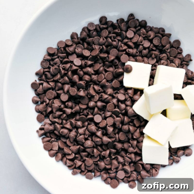 Melting Chocolate Chips and Butter for Fudgy Gluten-Free Brownies A stainless steel bowl filled with high-quality semi-sweet chocolate chips and perfectly cubed unsalted butter, ready to be gently melted together to form the luxurious base for these rich gluten-free brownies.