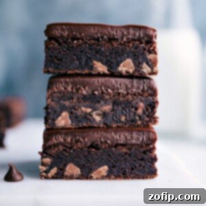 Decadent Gluten Free Brownies 2 A close-up of a perfectly fudgy gluten-free brownie stack, revealing a moist, rich interior with abundant melted chocolate chips, tempting any chocolate enthusiast to indulge.