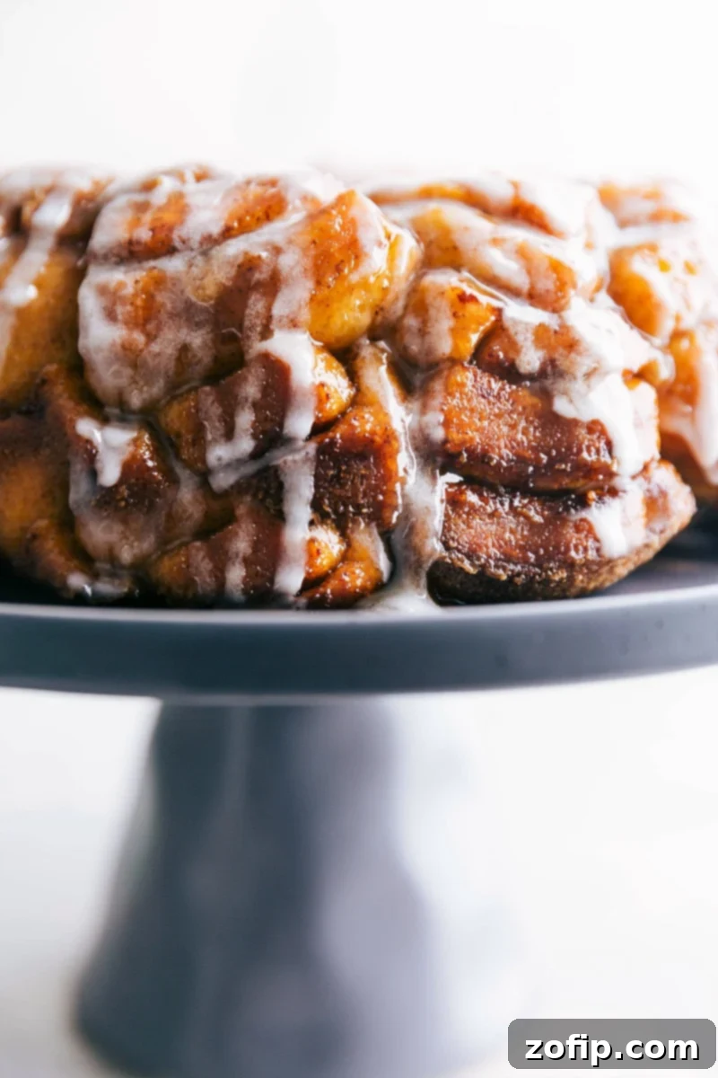 The finished cinnamon roll monkey bread recipe with the cream cheese frosting, showcasing the texture and flavor of this delightful dessert.
