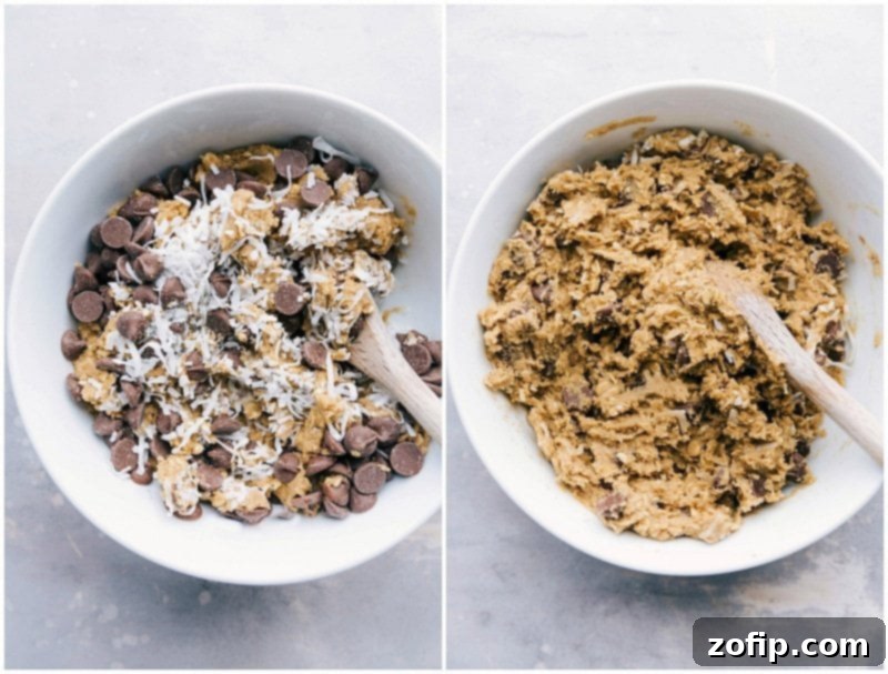 Cookie dough being mixed in a bowl, with chocolate chips and shredded coconut visible, ready for baking.