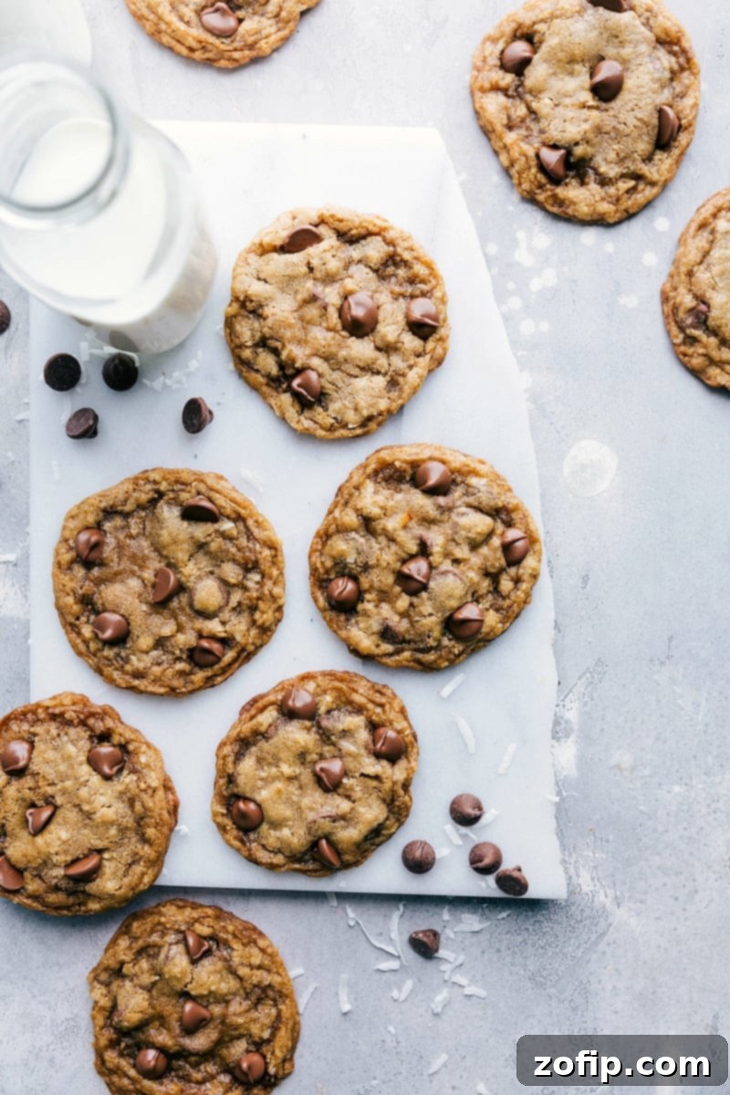 A beautiful display of freshly baked oatmeal coconut chocolate chip cookies, stacked and ready to be enjoyed, highlighting their golden hue and inviting texture.