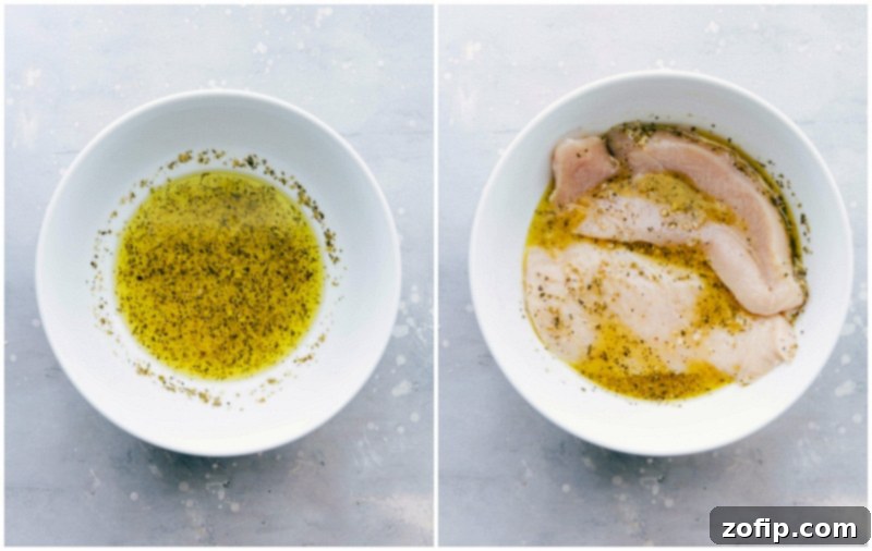 Chicken being added to a bowl filled with a flavorful greek chicken marinade, showcasing the marinating process that enhances the taste of this recipe.