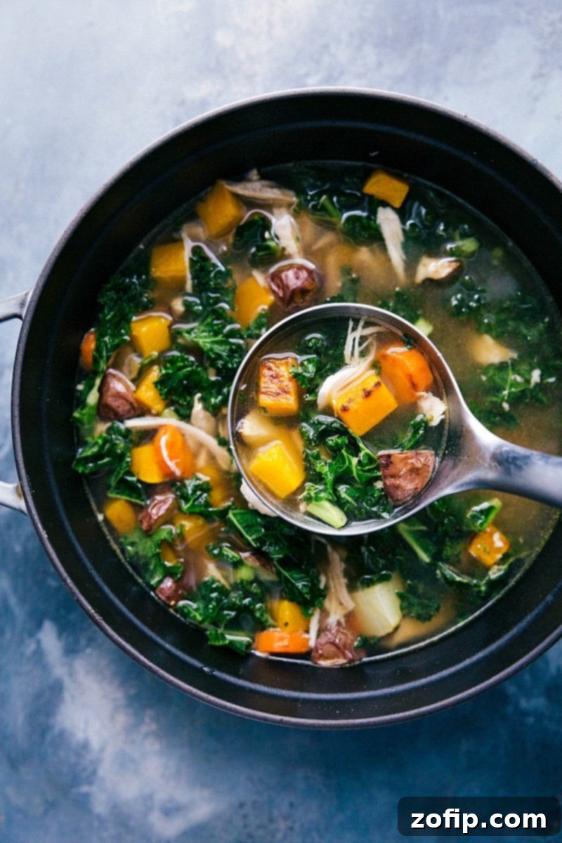 Steaming chicken vegetable soup in a rustic pot, with a ladle ready to serve a hearty portion.