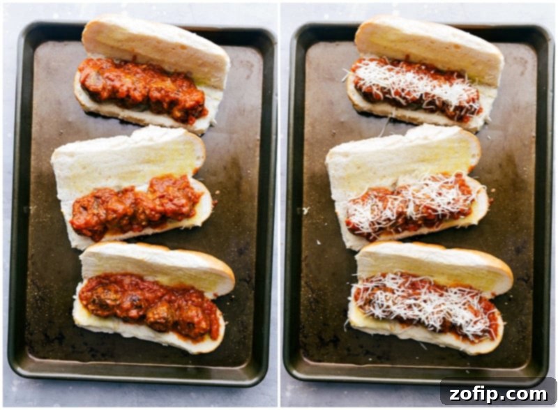 Open-faced meatball subs generously topped with melted cheese, arranged on a baking sheet, ready for a final broil to achieve a golden, bubbly finish.