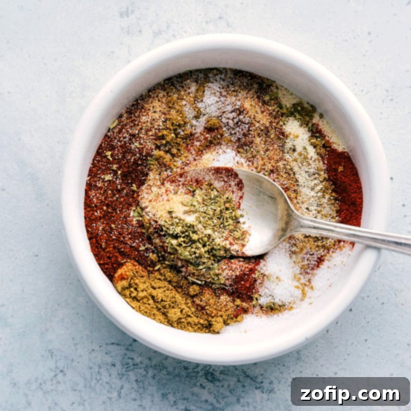 A bowl filled with a mixture of seasonings and spices, being combined to create a flavorful seasoning blend for the shrimp fajita recipe.