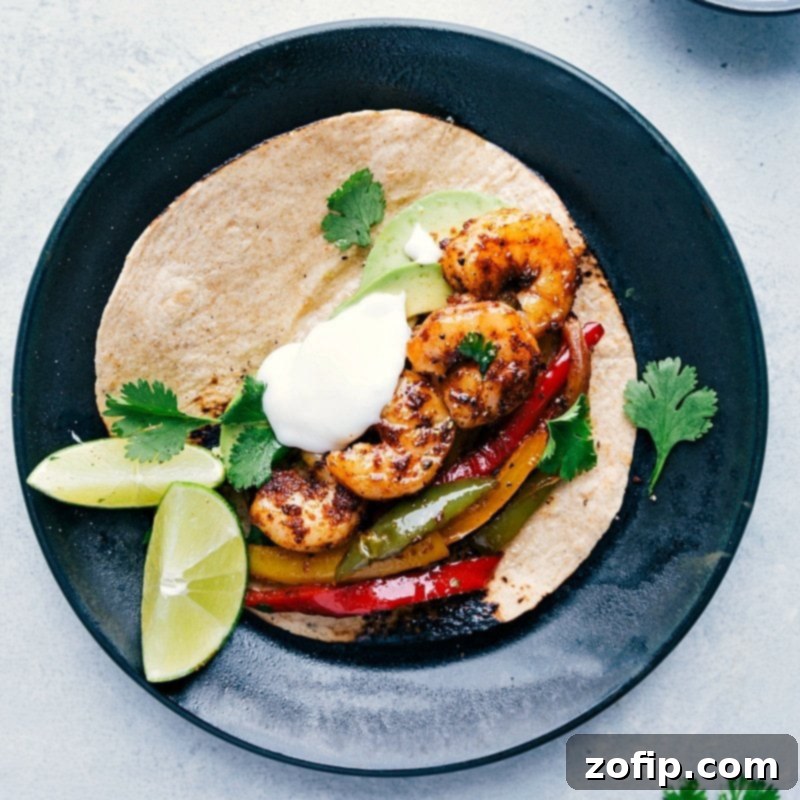 A tortilla filled with freshly baked seafood and vegetables, garnished with fresh herbs, sour cream, and limes, creating a mouthwatering and visually appealing dish.