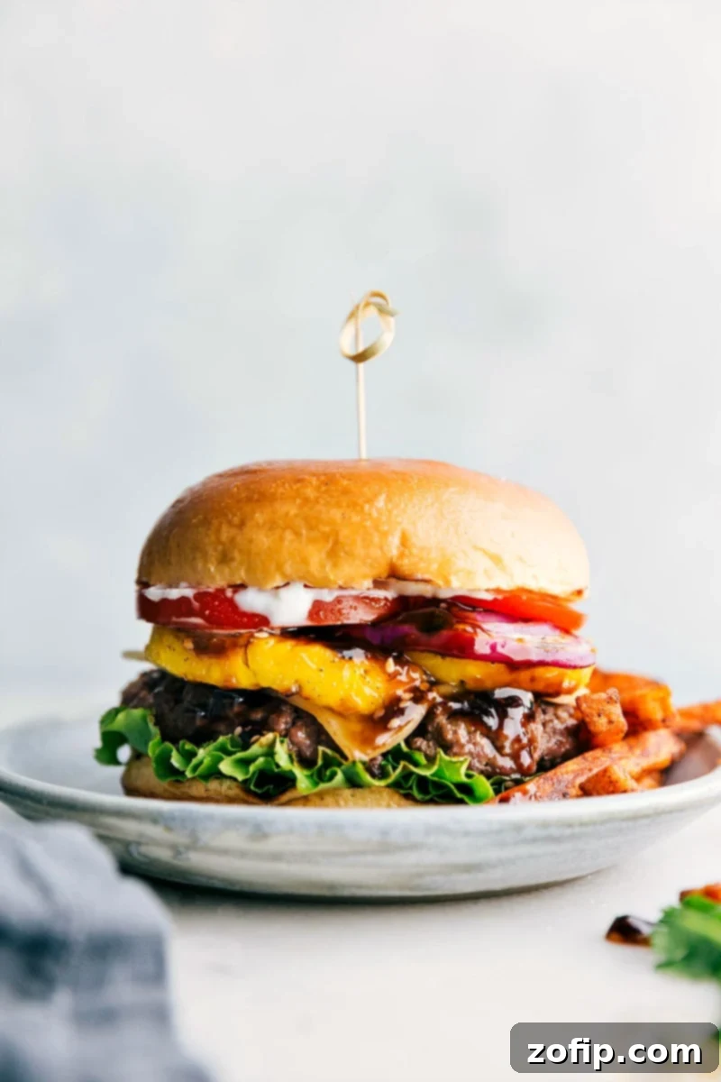 Ready to eat delicious and flavor-packed teriyaki burger, complete with all its toppings between a buttery bun and fries on the side.