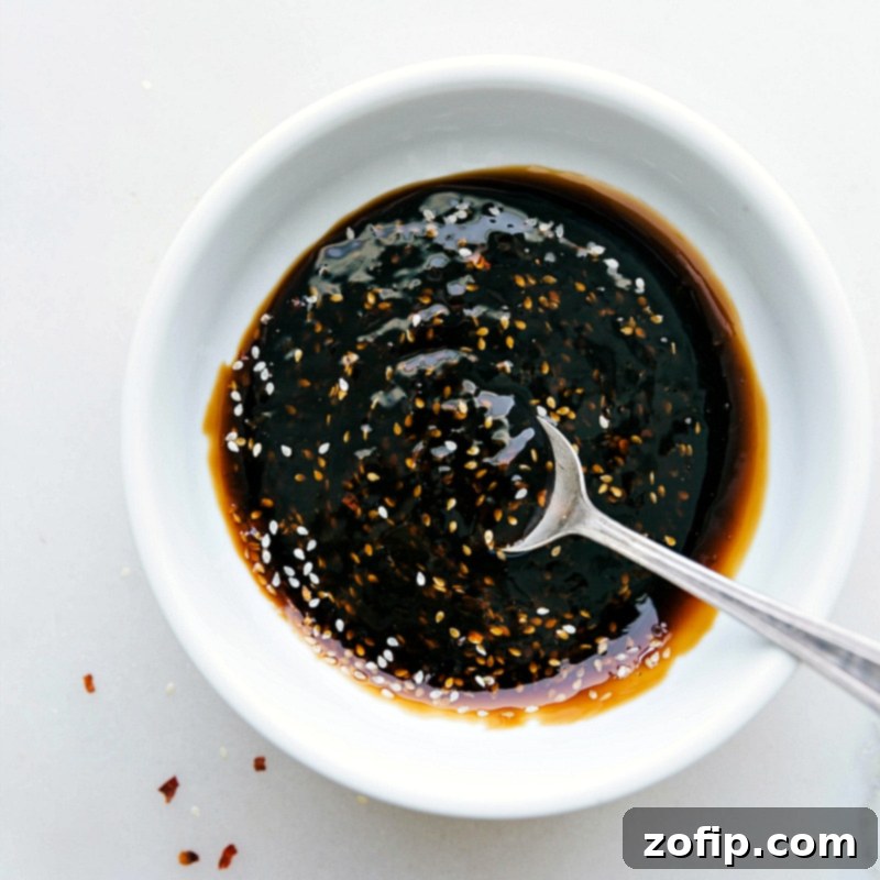 Homemade teriyaki sauce in a bowl, thick and flavorful, prepared for enhancing the meal.