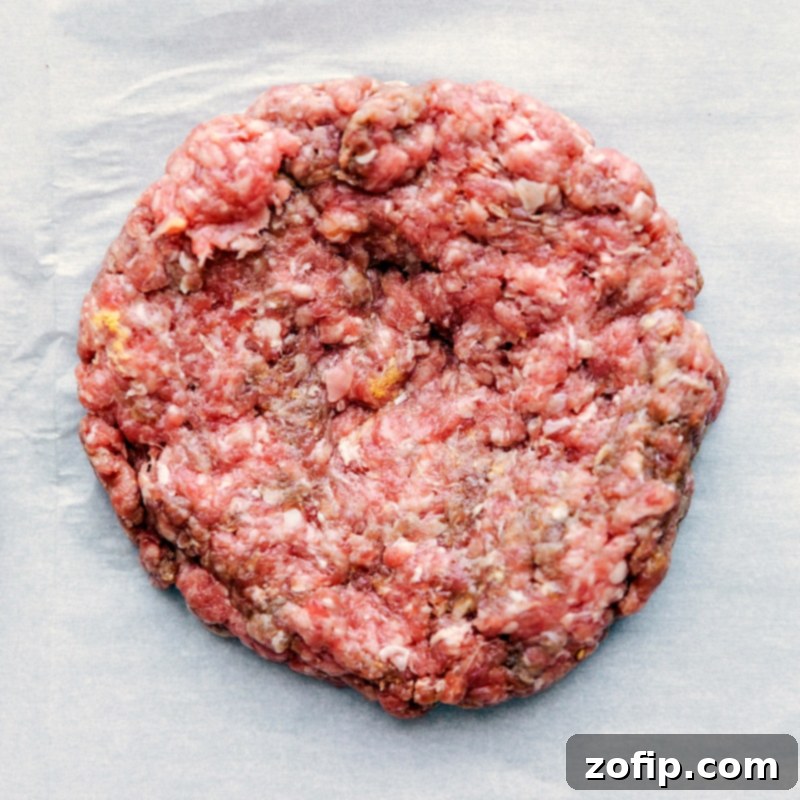 Raw patty showcasing the technique of shaping the meat.