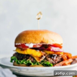 Ready to eat delicious and flavor-packed teriyaki burger, complete with all its toppings between a buttery bun and fries on the side.