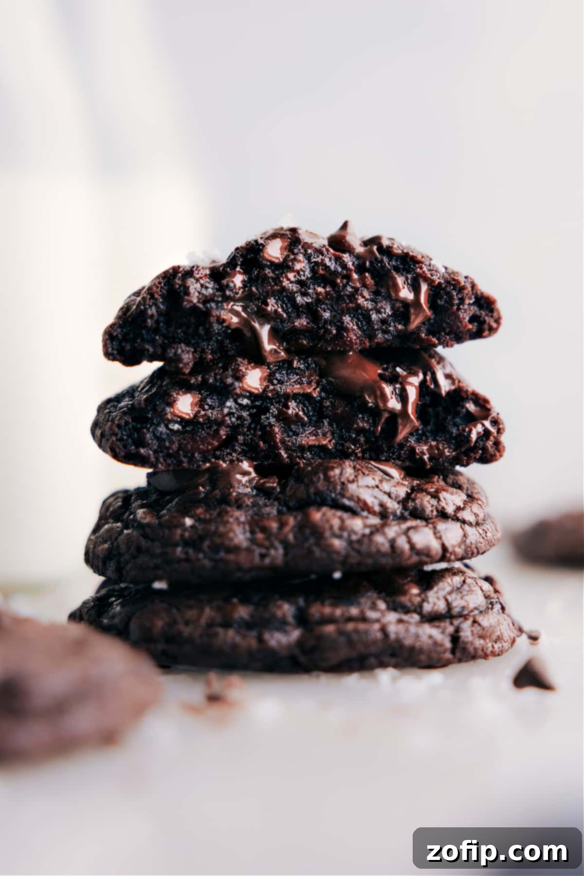 A tall stack of rich, fudgy chocolate cookies, perfectly baked and ready to be enjoyed, with a soft blur indicating warmth and deliciousness.