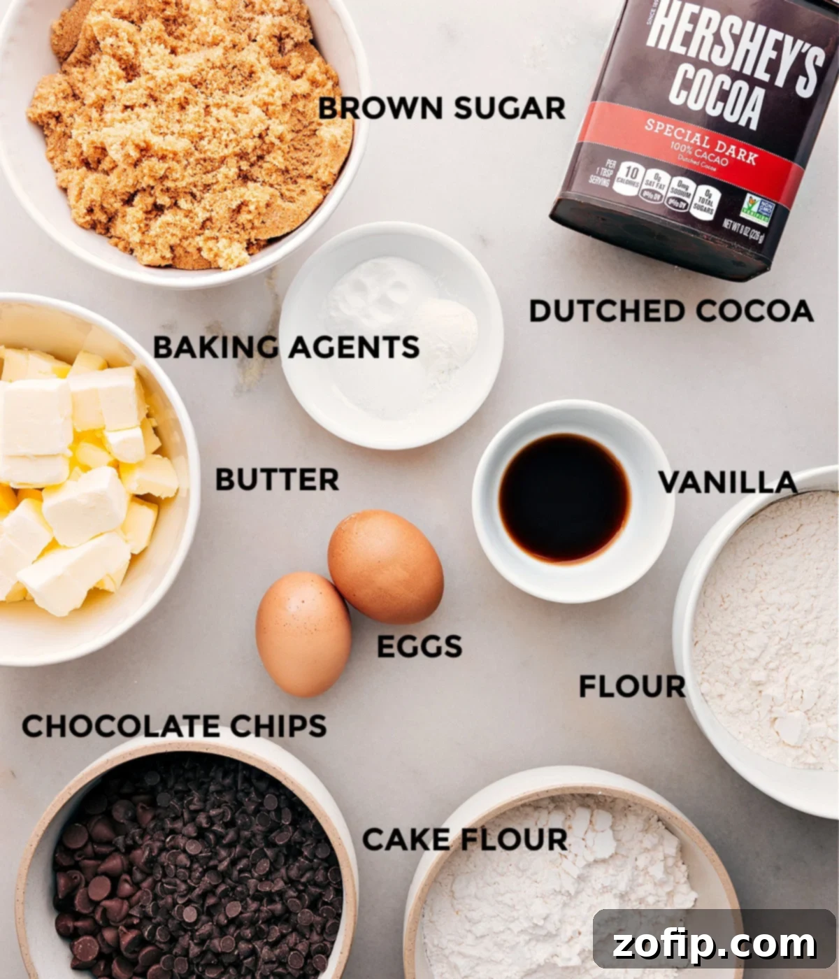 An inviting overhead shot of all the essential ingredients for making delicious chocolate cookies, neatly arranged on a rustic wooden surface, ready for baking.