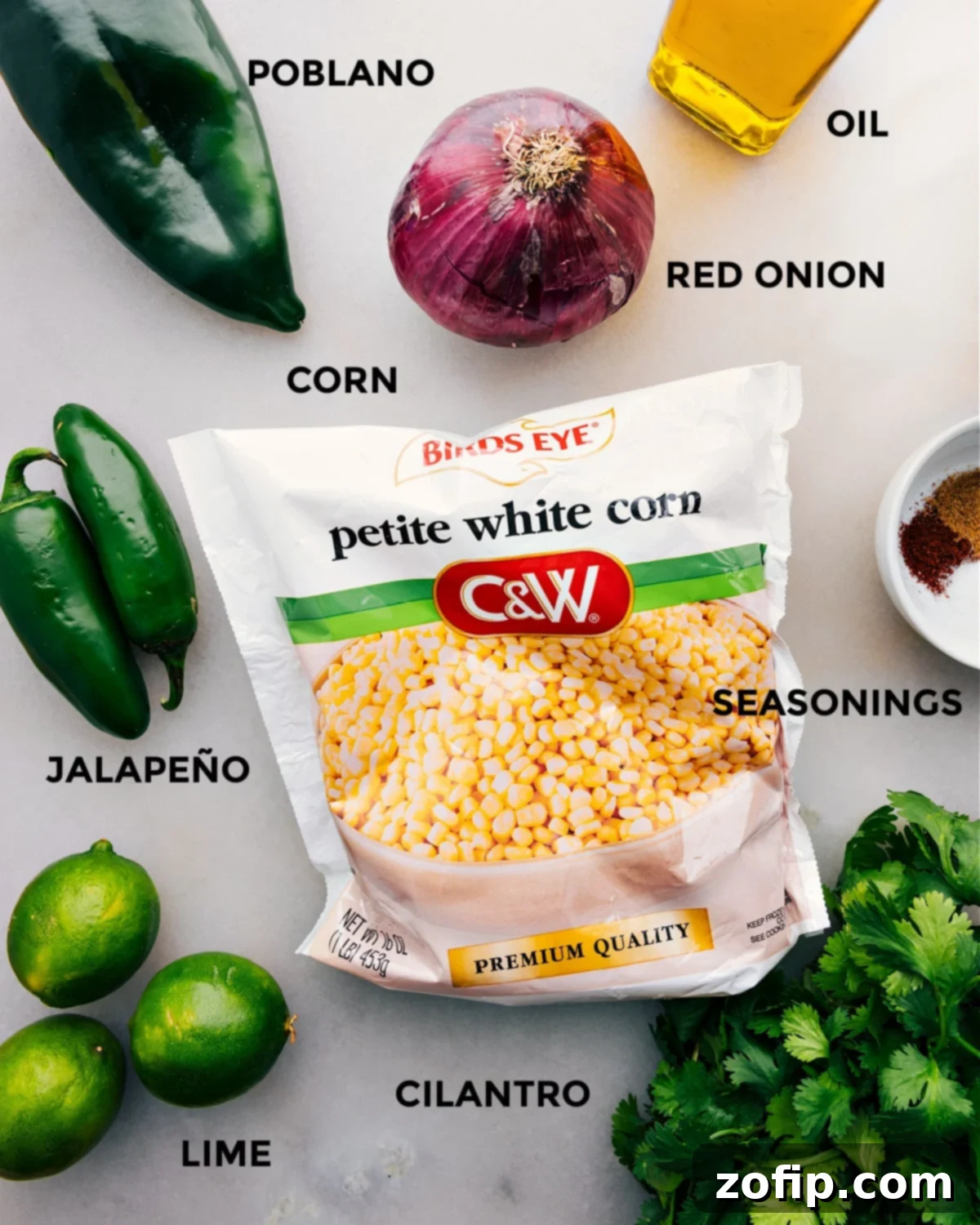 Ingredients laid out on table with titles Fresh ingredients for corn salsa laid out on a table with descriptive titles