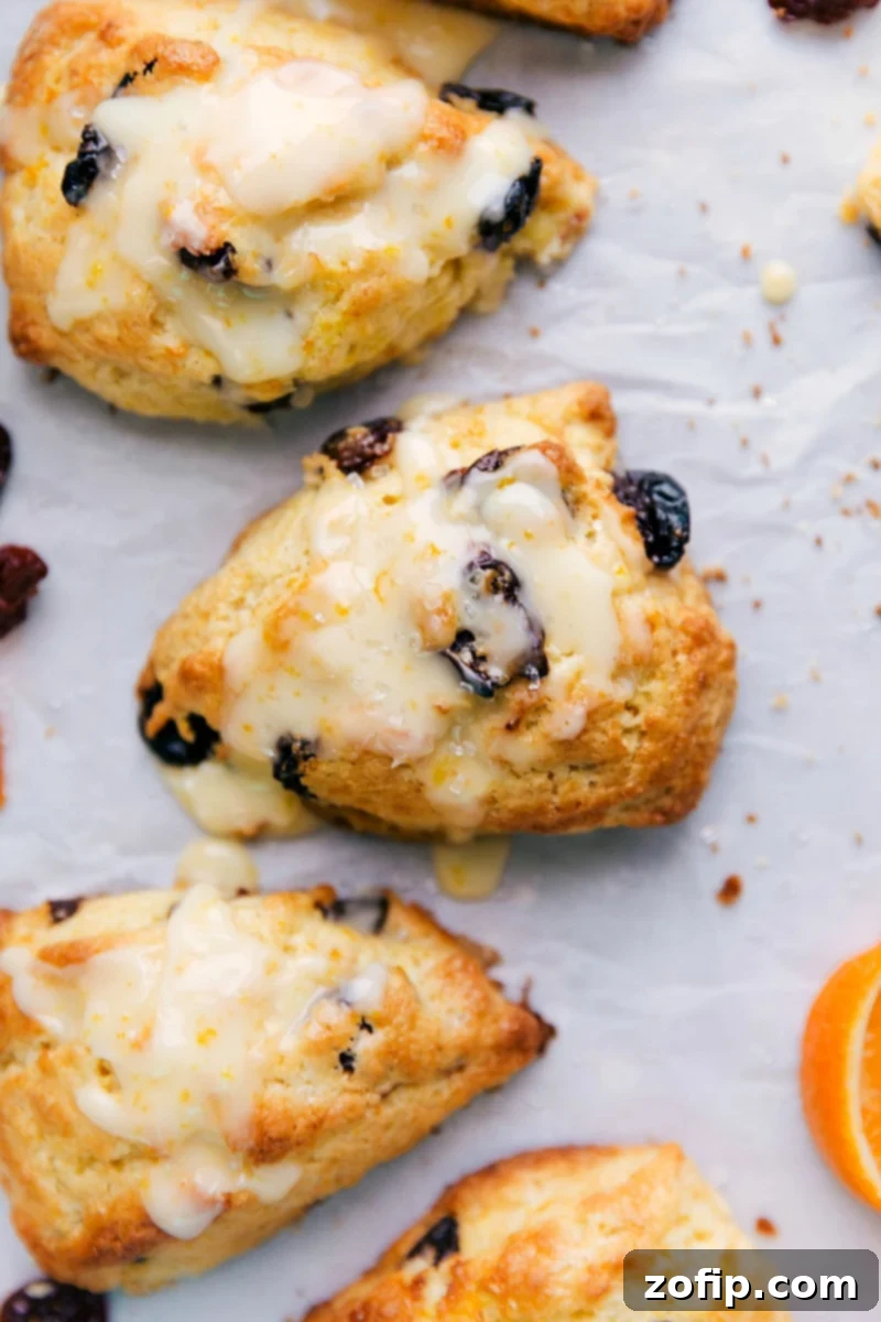 Delightful tart cherry scones with a drizzling of sweet glaze on top, a scrumptious dessert ready to be savored.
