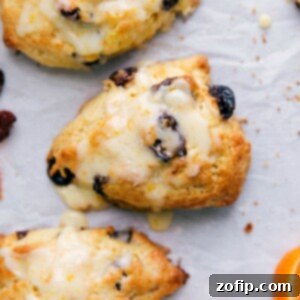 Delightful tart cherry scones with a drizzling of sweet glaze on top, a scrumptious dessert ready to be savored.