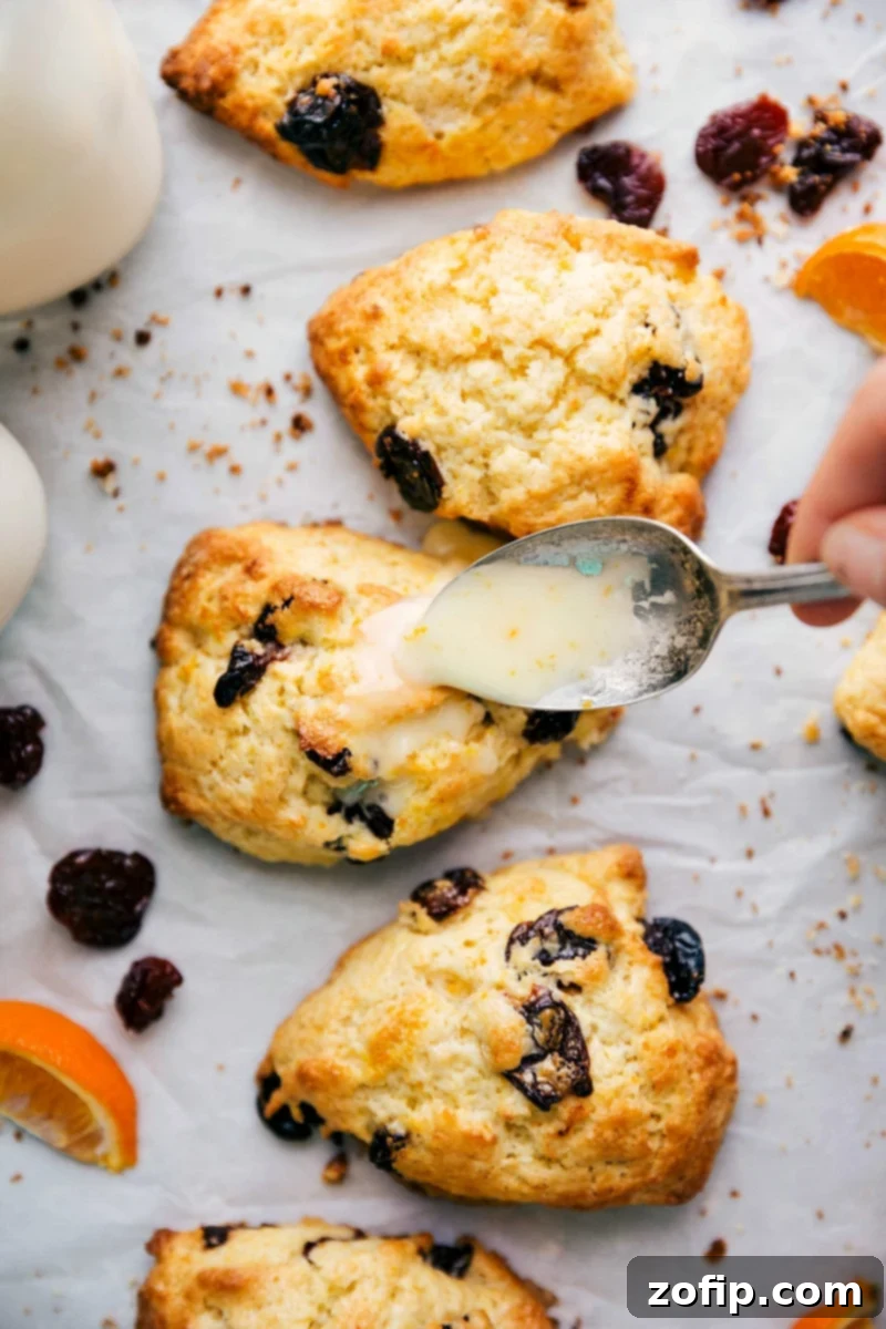 Applying a sweet glaze to the top of the golden-brown desserts, making them even more enticing and ready to be enjoyed.